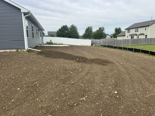 Raked, graded bare soil in a new home's backyard